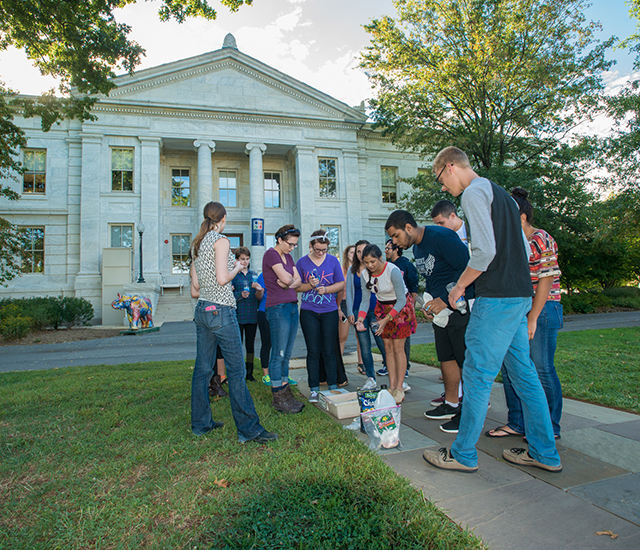 Students participating in a science experiment in the quad.
