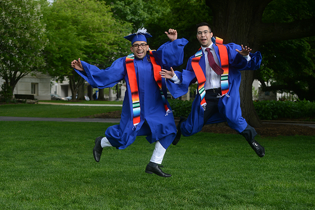 Two AU students jumping for joy at graduation!