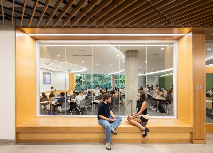 Hall of Science classroom with students chatting in adjacent hall.