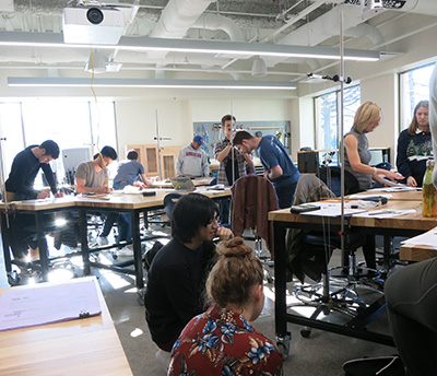 Engineering students working at tables in a classroom