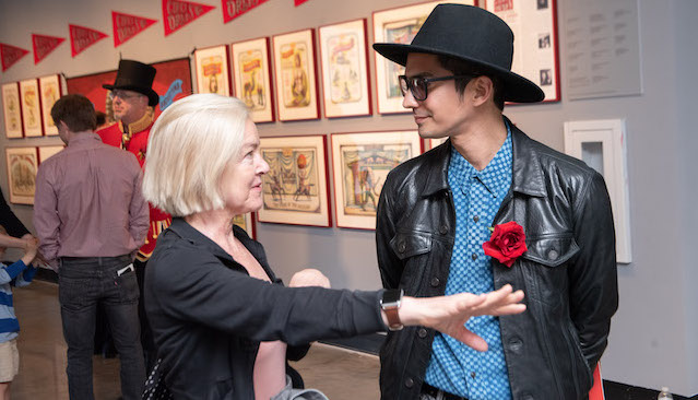 An artist talking to a patron