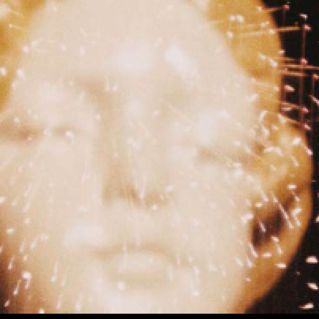 Detail of LOOKING FOR MUSHROOMS 1959-67/1996. Film still of a woman's face superimposed with fireworks.