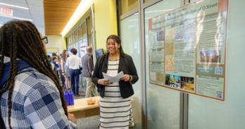 Katharine Grace McCartha presents her winning poster, Buried Histories: Examining Anti-Blackness in the Afterlives of Q Street