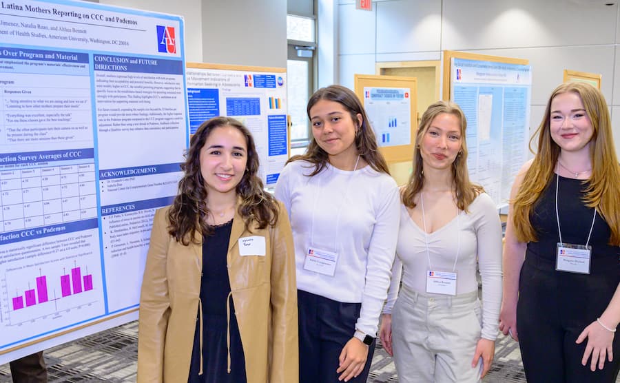 Four students with posters.