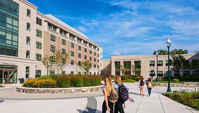 Students walking by East Campus buildings