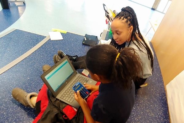 Keana Brooks (SOC '22) working with a student before tutoring moved online