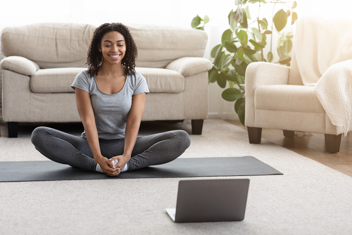 woman doing virtual yoga class