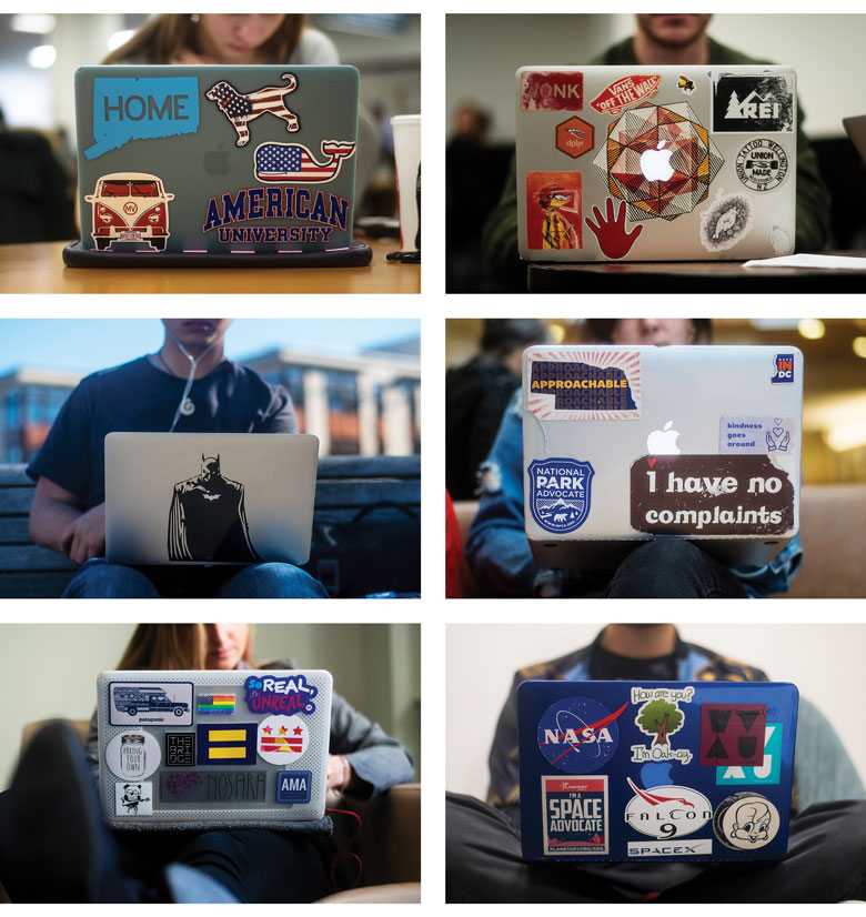 six laptops decorated with an array of colorful stickers