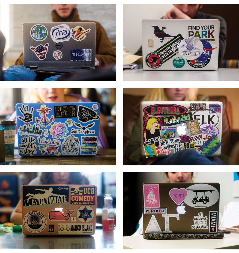 six laptops decorated with an array of colorful stickers