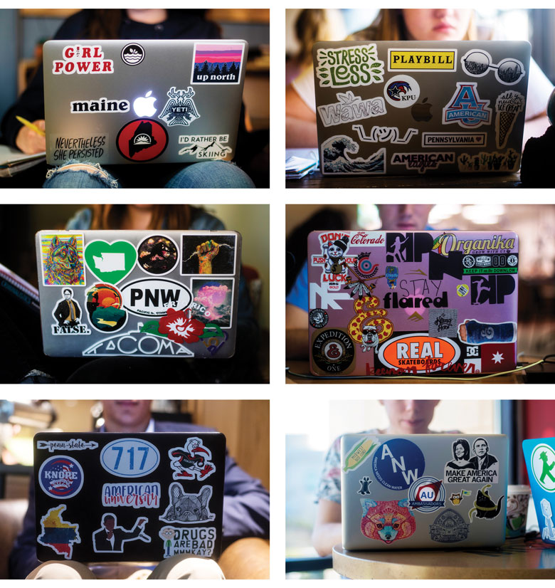 six laptops decorated with an array of colorful stickers