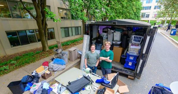 From left, zero waste manager Caroline Boone and Luke Carignan, CAS/BS ’25, BA ’25, stand next to one of the Project Move Out pods. Photo by Jeff Watts.