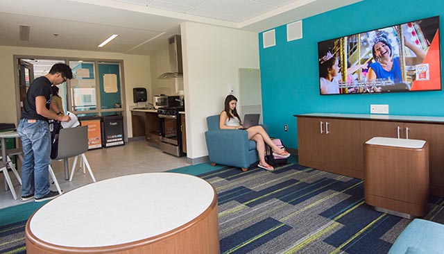 Students in room with Televisions on wall