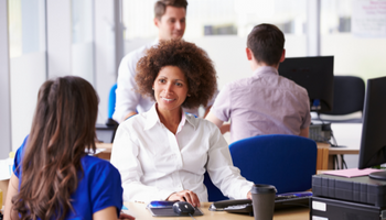 A female student services representative assisting a graduate student