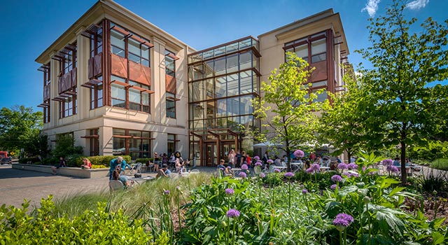 School of International service building exterior with garden and students outside