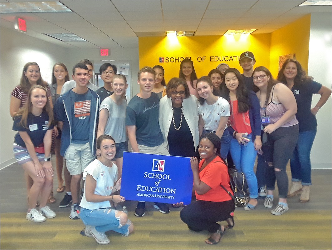 Elem Ed class in front of an AU SOE banner