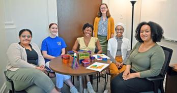 Assistant Professor Dr. Emily Grossnickle Peterson with students preparing to research children's visual processing and spatial thinking at DC's Martin Luther King, Jr. Library.