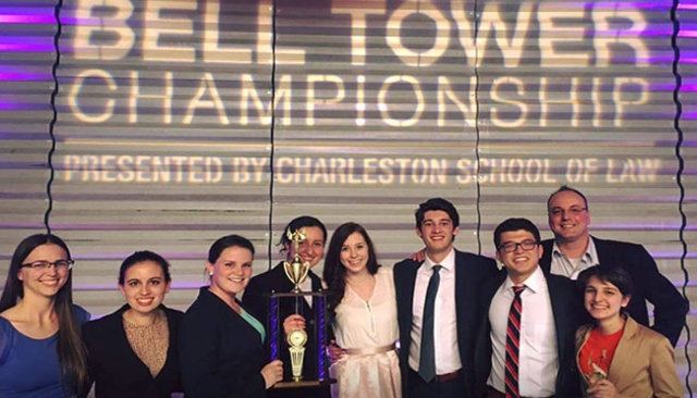 Mock trial team holds trophy.