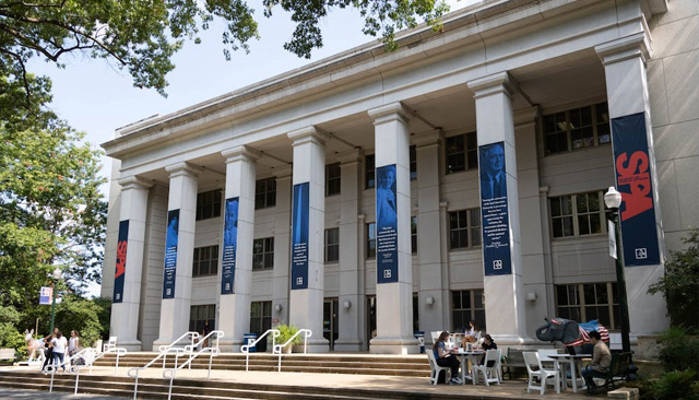 The front of Kerwin Hall during the day with some students sitting at tables in front of the building, taken by The Eagle's Joshua Katz.