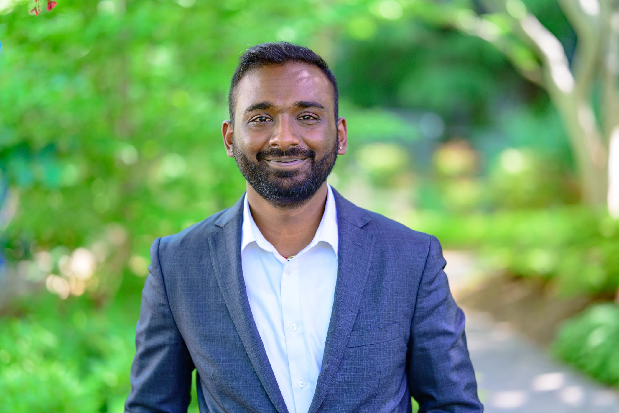 Graduate student Sriman Thangaraj stands outside.