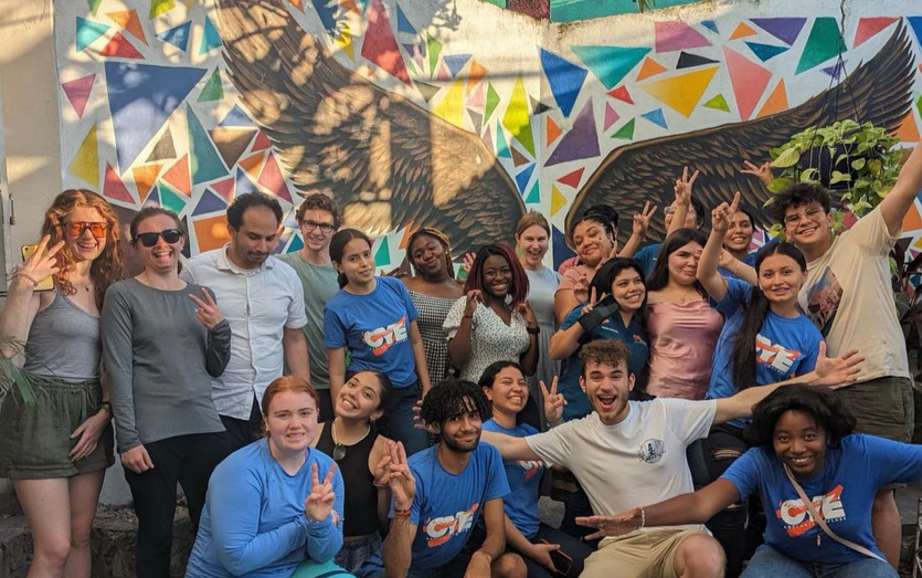 Students posing in front of mural during Colombia Alternative Break program.