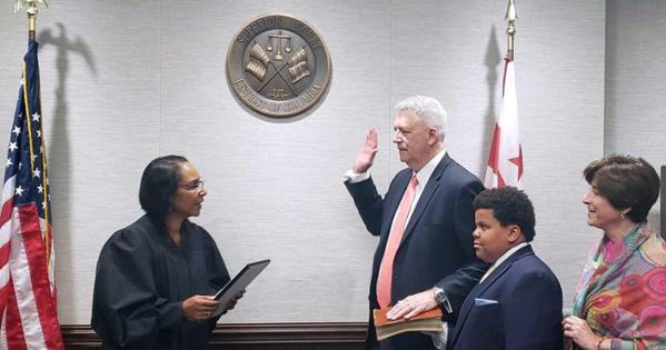 Judge Robert J. Hildum being sworn in.