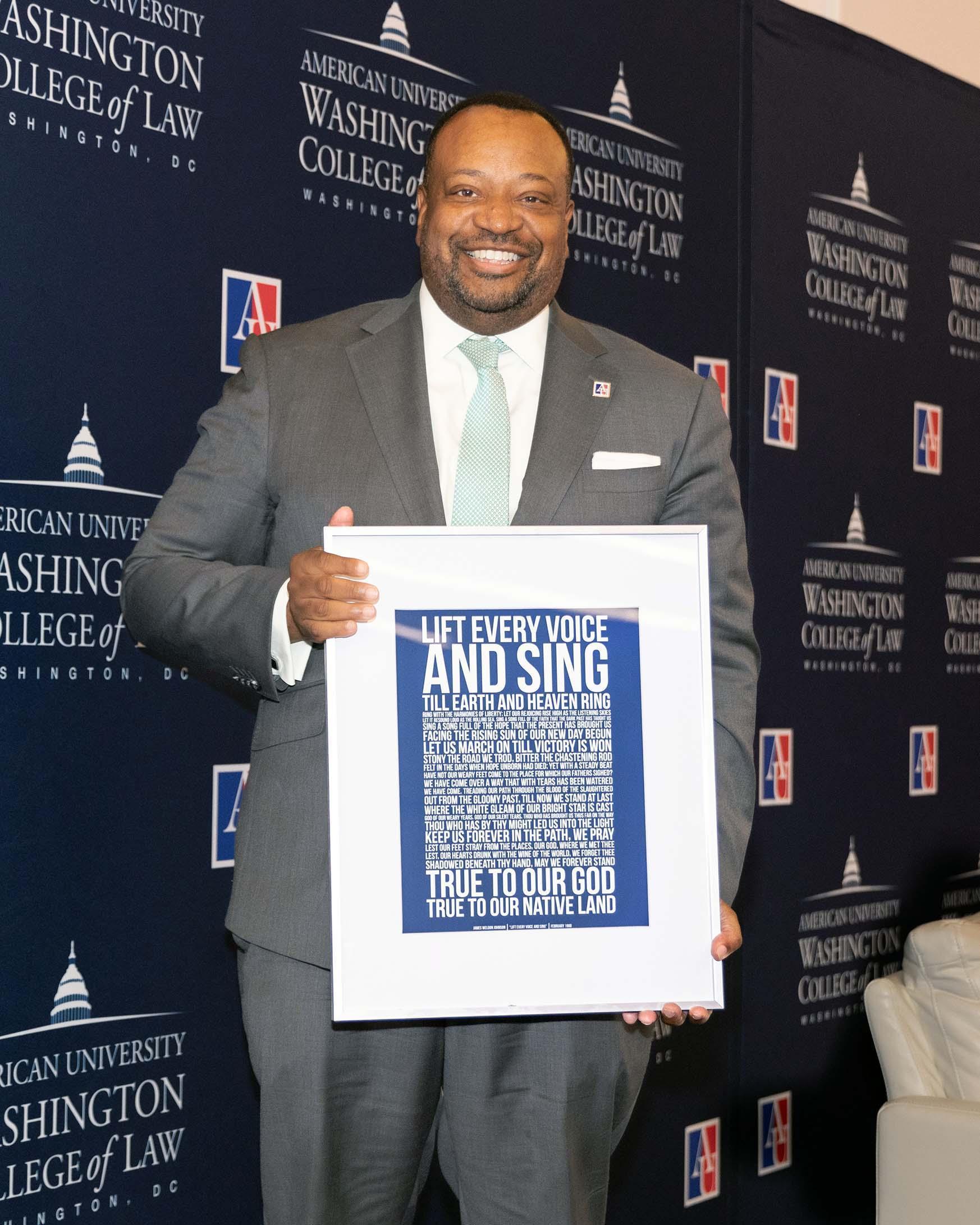 Dean Fairfax with a framed copy of the Black National Anthem, "Lift Every Voice." Dean Fairfax with a framed copy of the Black National Anthem, "Lift Every Voice."