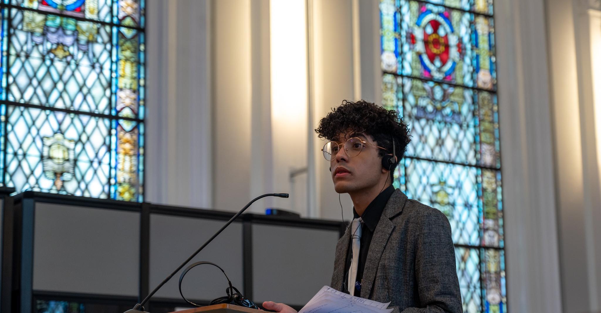 A participant in the Moot Court Competition argues their case to the panel of judges A participant in the Moot Court Competition argues their case to the panel of judges